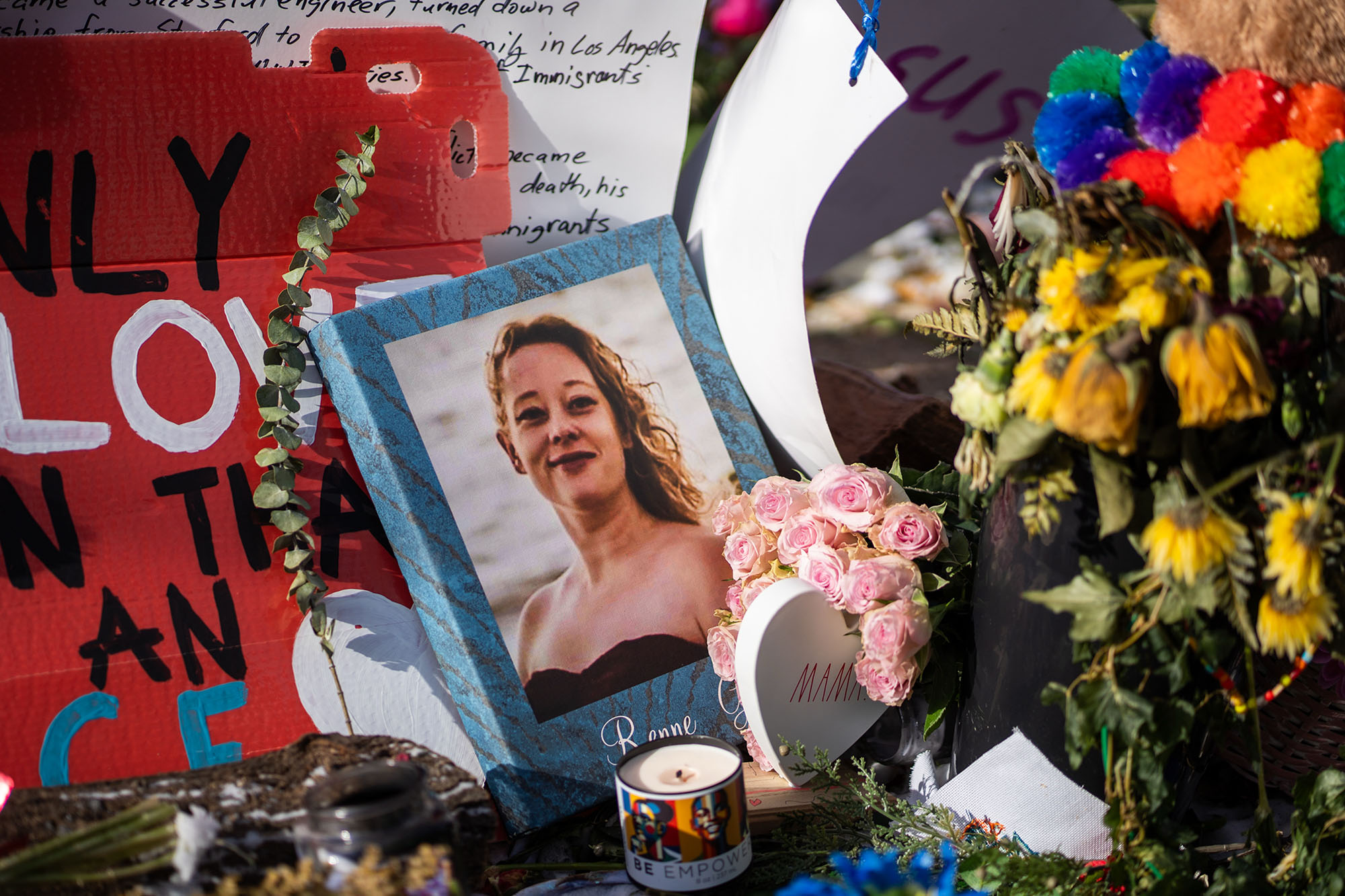 Memorial with flowers and a photo of Renee Good.