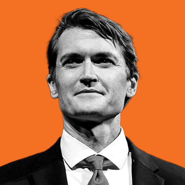 A middle-aged man with and a defined jawline in a suit and tie. 