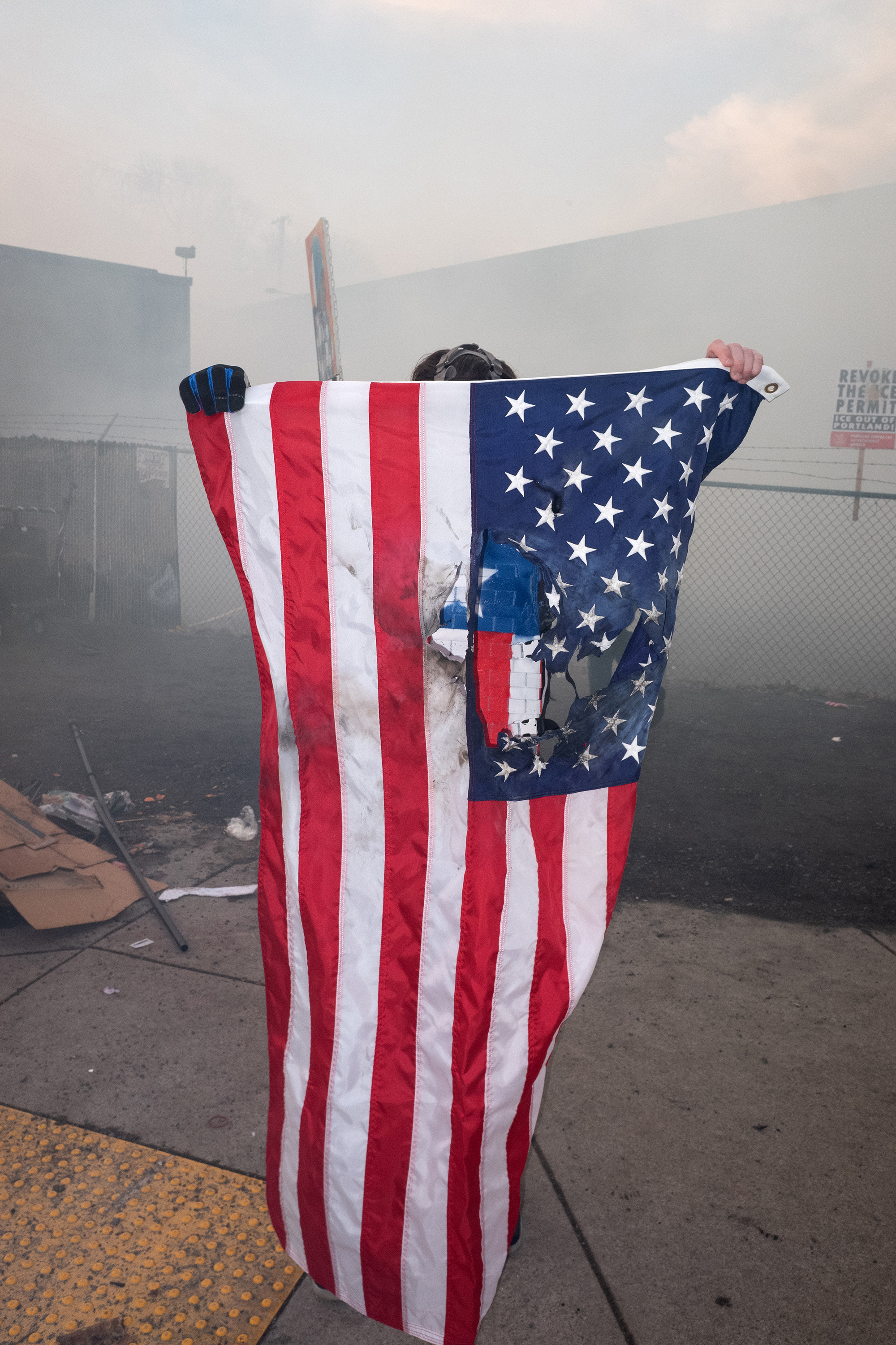 Person holding a torn American flag.