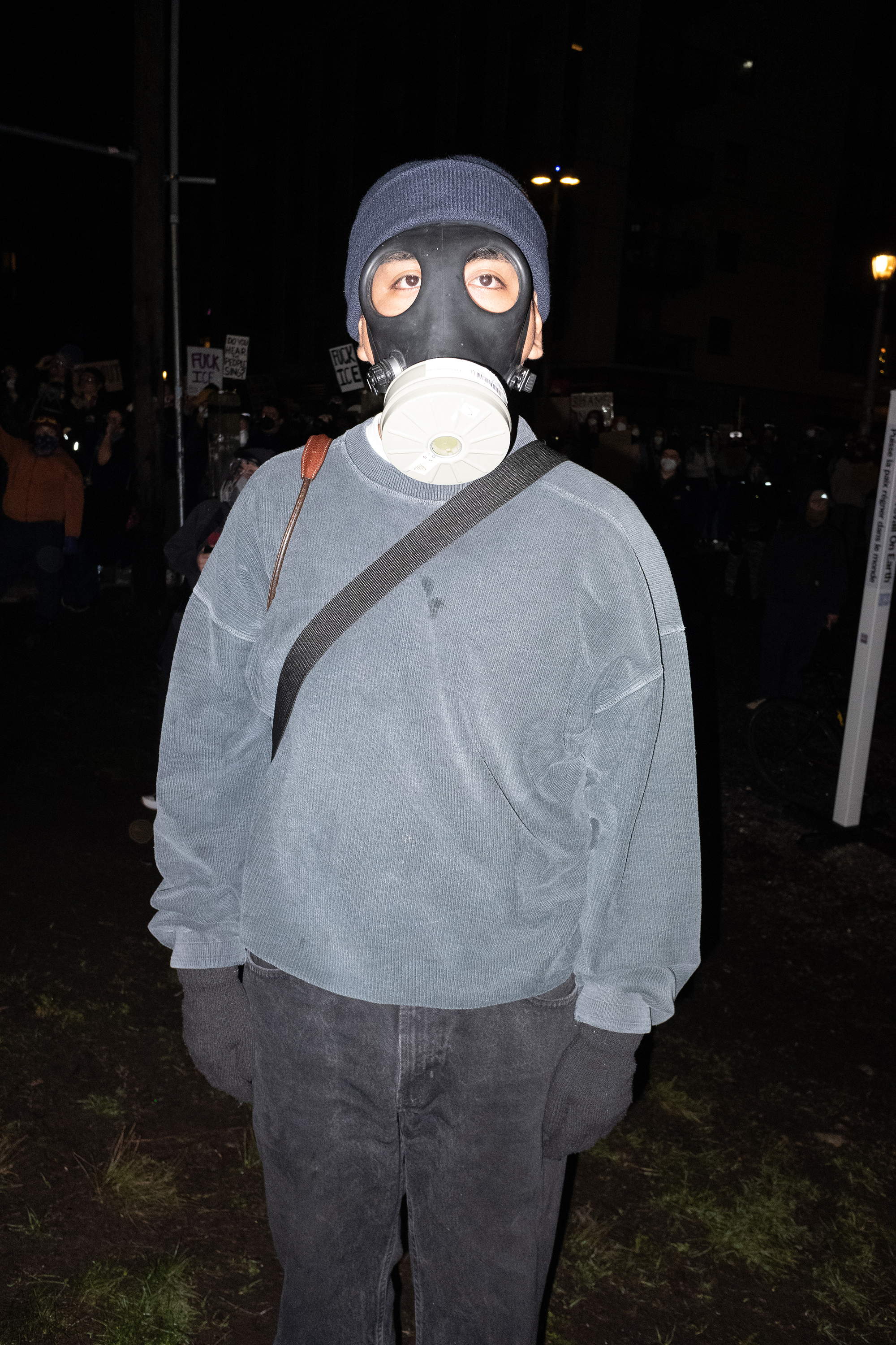 Person wearing gas mask at a protest.