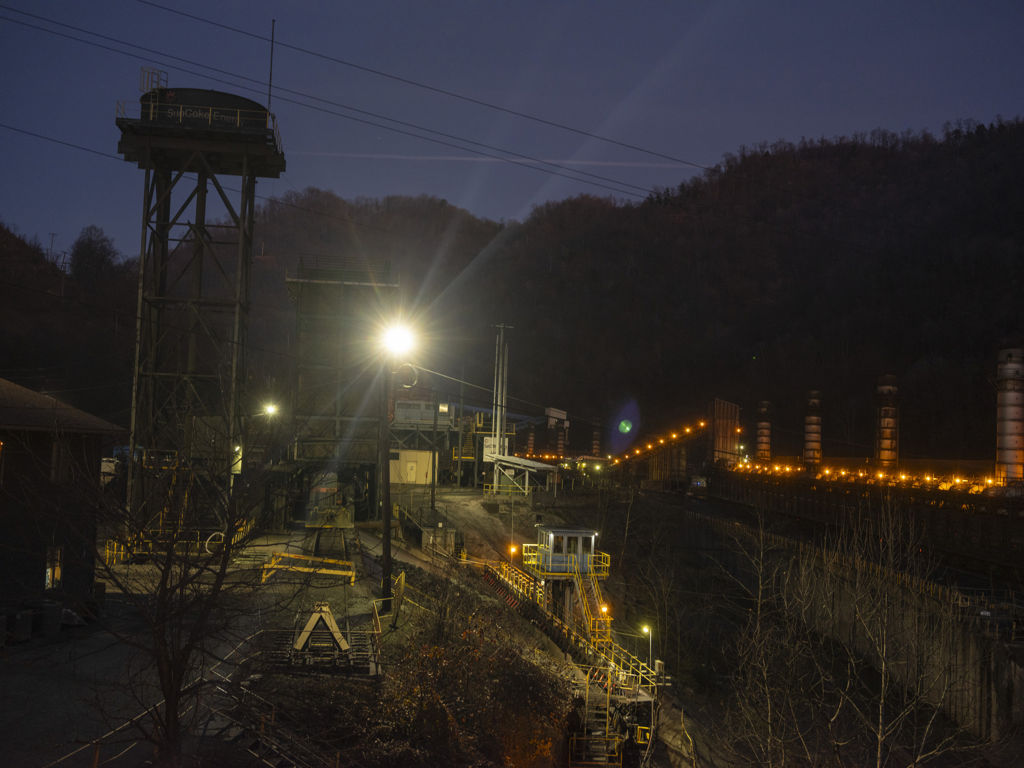 Night image of an energy plant with lights illuminating the machinery.