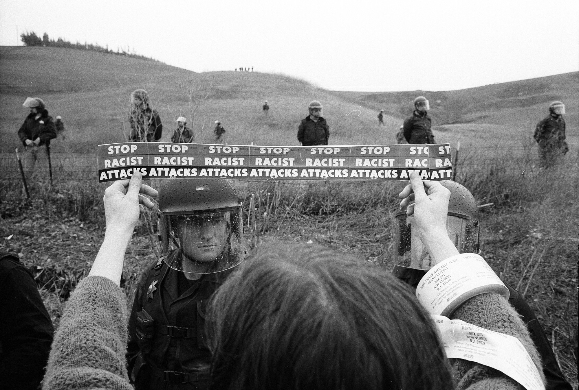 Archival photo of a protestors view outside of a white supremacist compound.