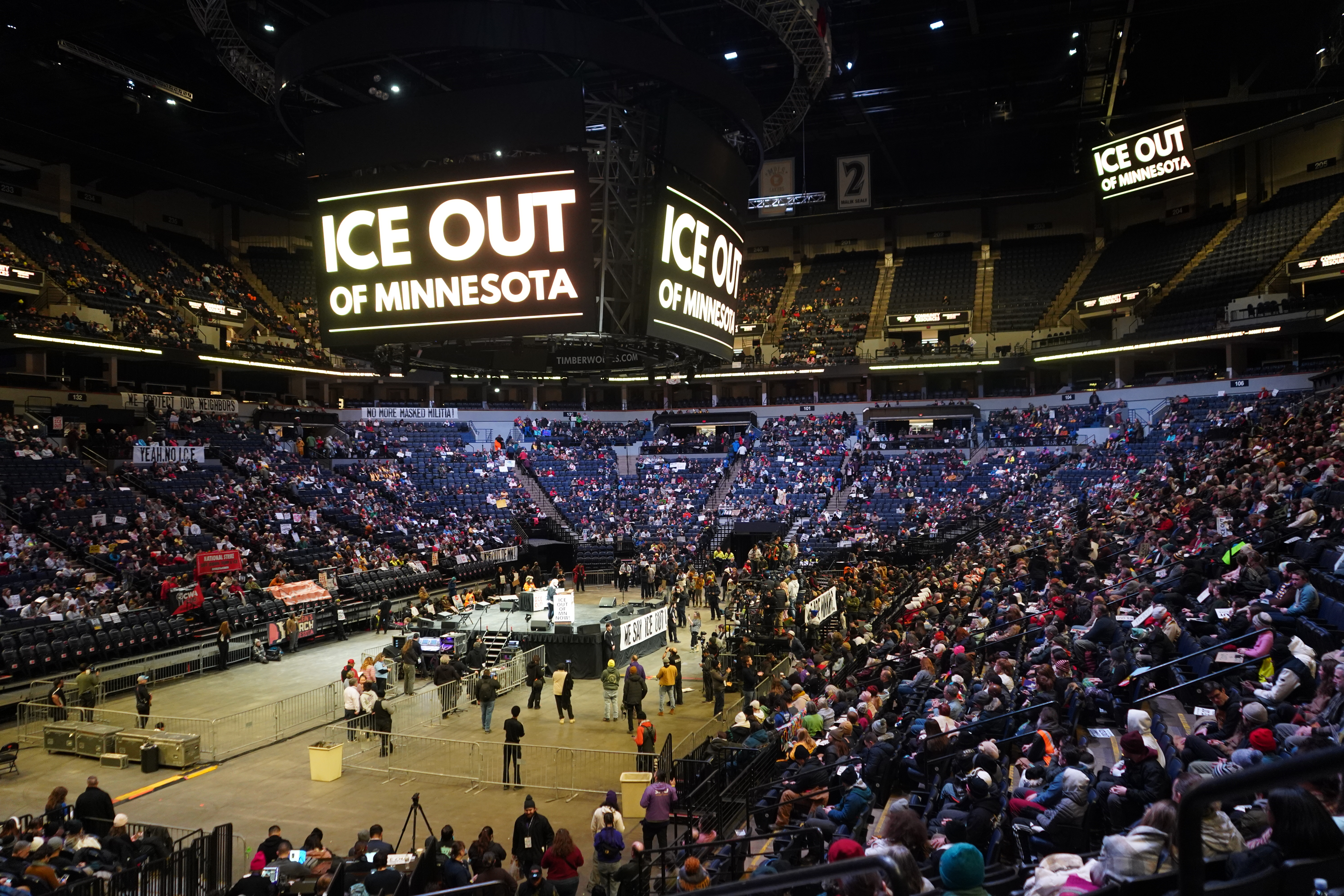 View of a basketball stadium full of people in support of an anti-ICE rally from the bleachers.