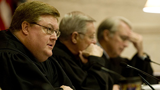 Justice Brent D. Benjamin addresses the West Virginia Supreme Court as it opens for the January 2009 term at the State Capitol in Charleston, W.Va. Tuesday, Jan. 13, 2009