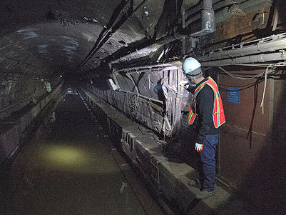 An MTA employee in a flooded tunnel